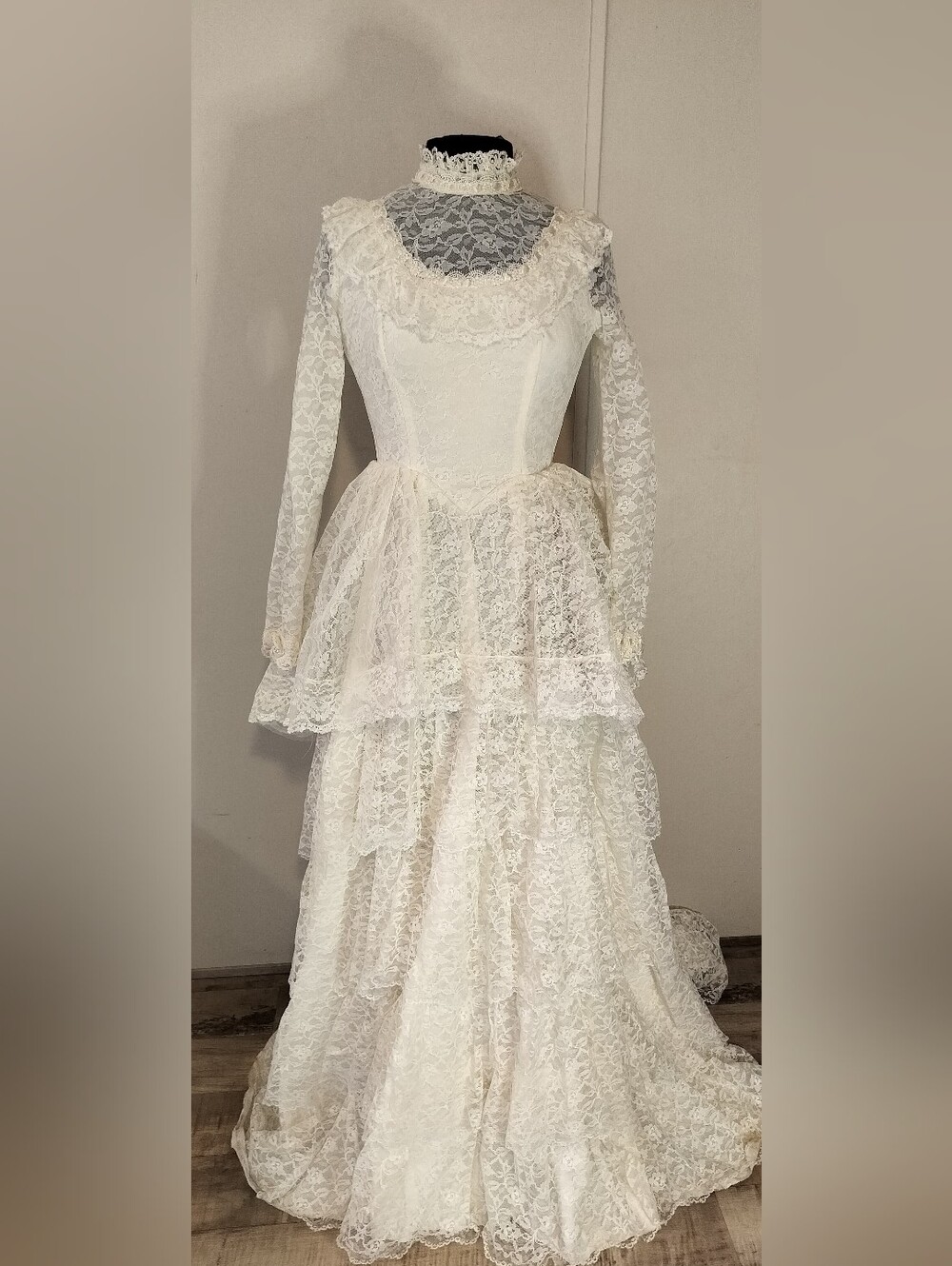 Vintage-Inspired Ivory Lace Wedding Dress with High Neck and Tiered Skirt
